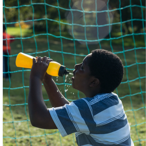 boy drinking from a refillable water bottle