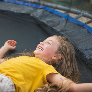 girl grinning on a trampoline