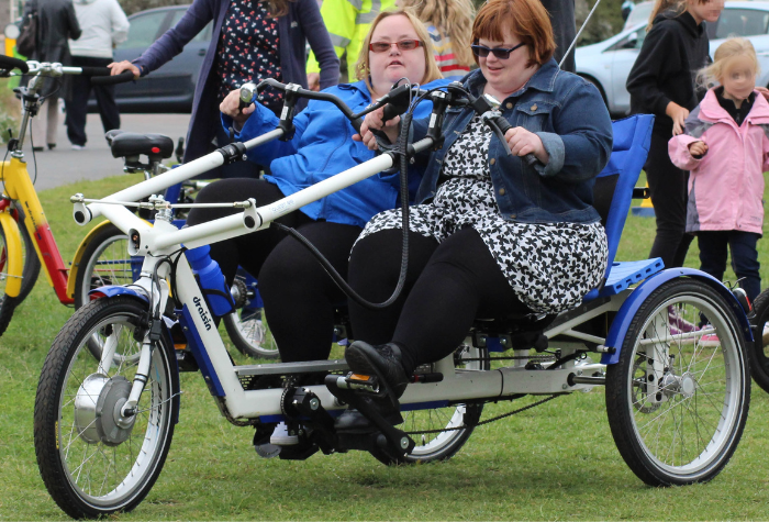 two women using an adapted cycle