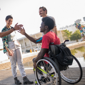 Three people chatting one in wheelchair