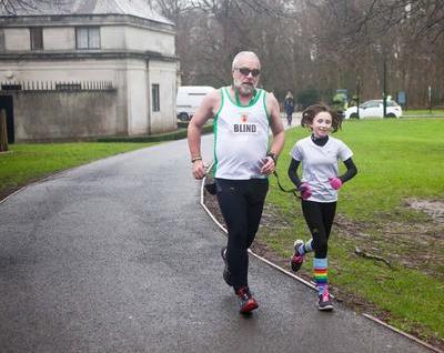 Tony and a girl running in a park