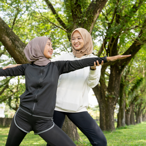 two women in hijabs doing yoga