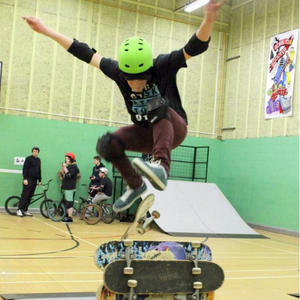 boy skateboarding indoors